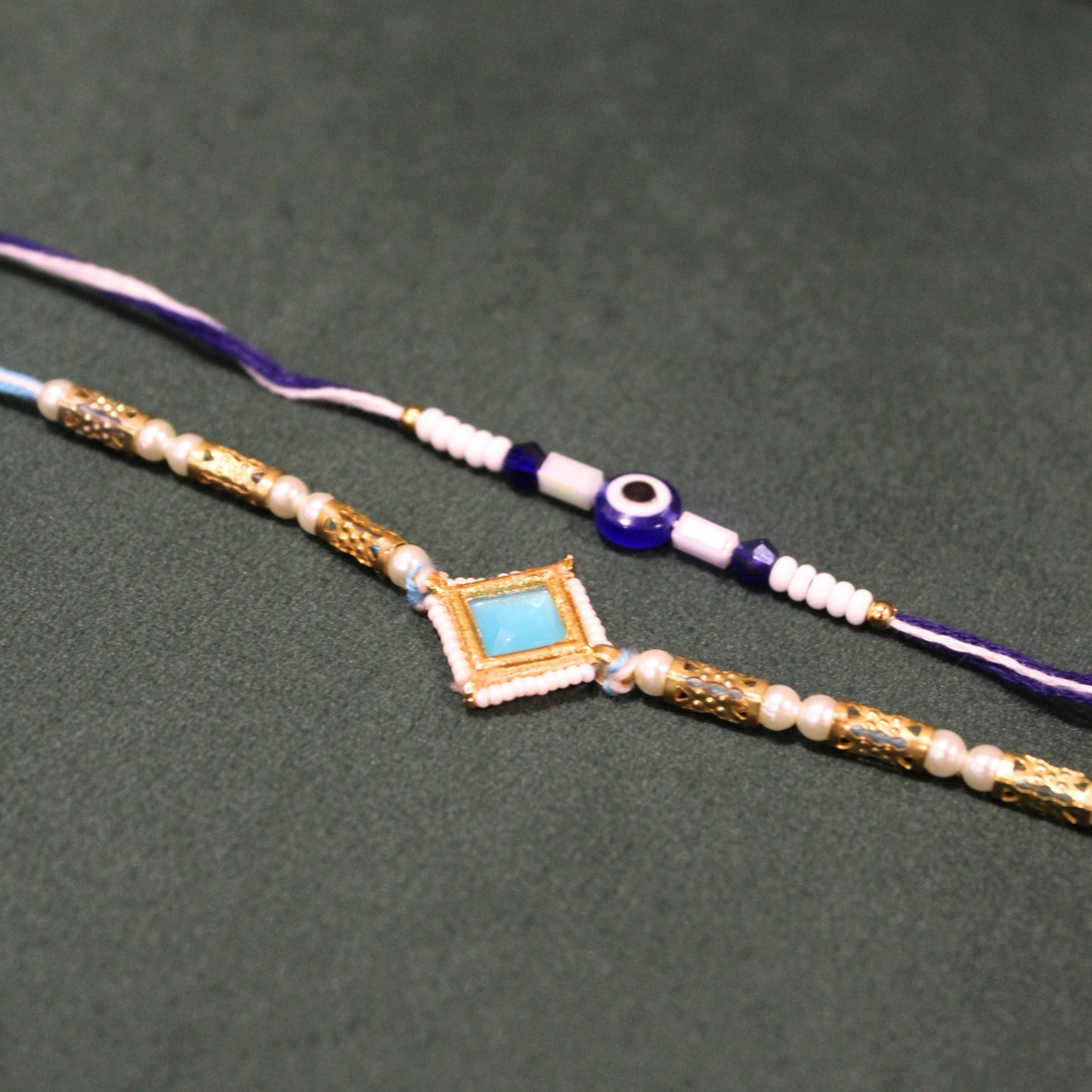 aqua evil eye rakhi set of 2