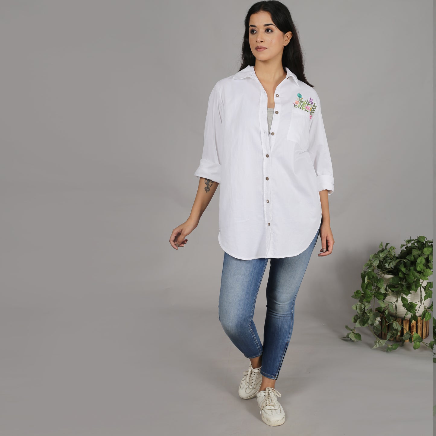 White shirt with floral embroidery on the pocket