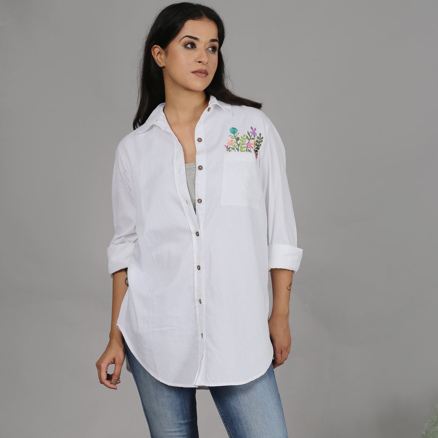 White shirt with floral embroidery on the pocket