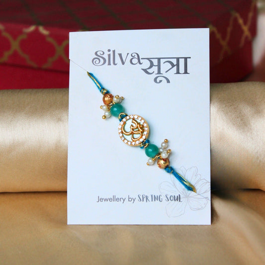 Turquoise Om Blue Pearl and Stonework Thread Rakhi - Spring Soul