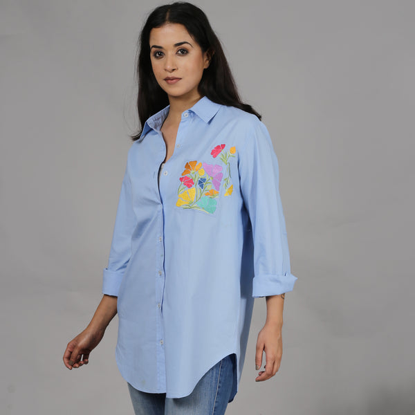 Blue shirt with floral embroidery on the pocket